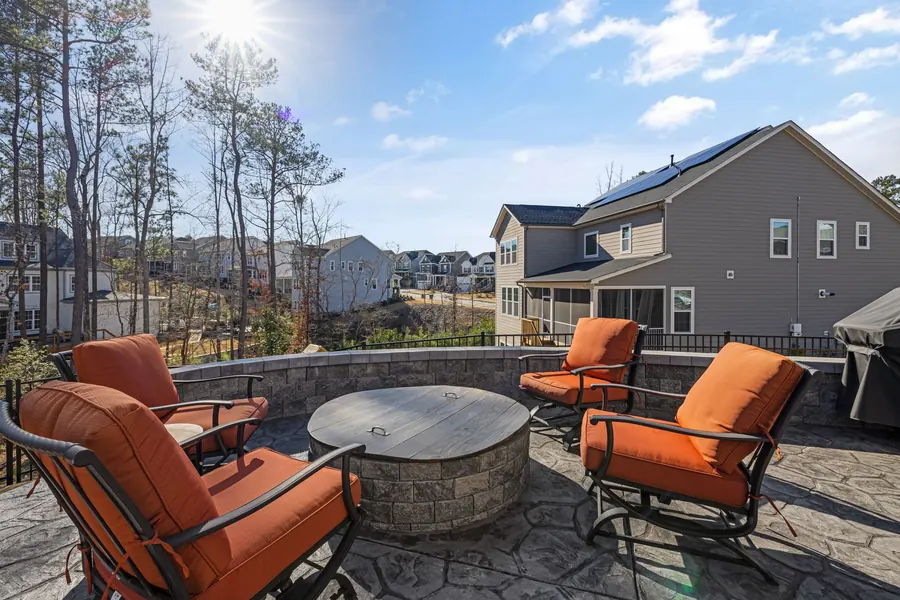 A finished patio with seating and a fire pit overlooking the garden