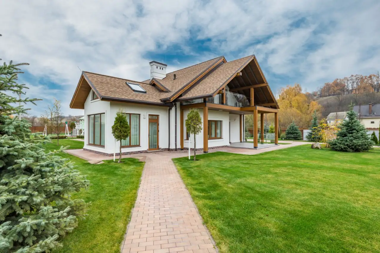 Cottage with a finished green garden