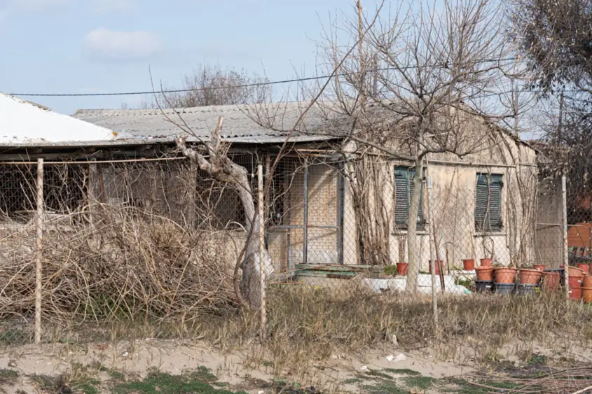 Neglected house with a bare, untended yard