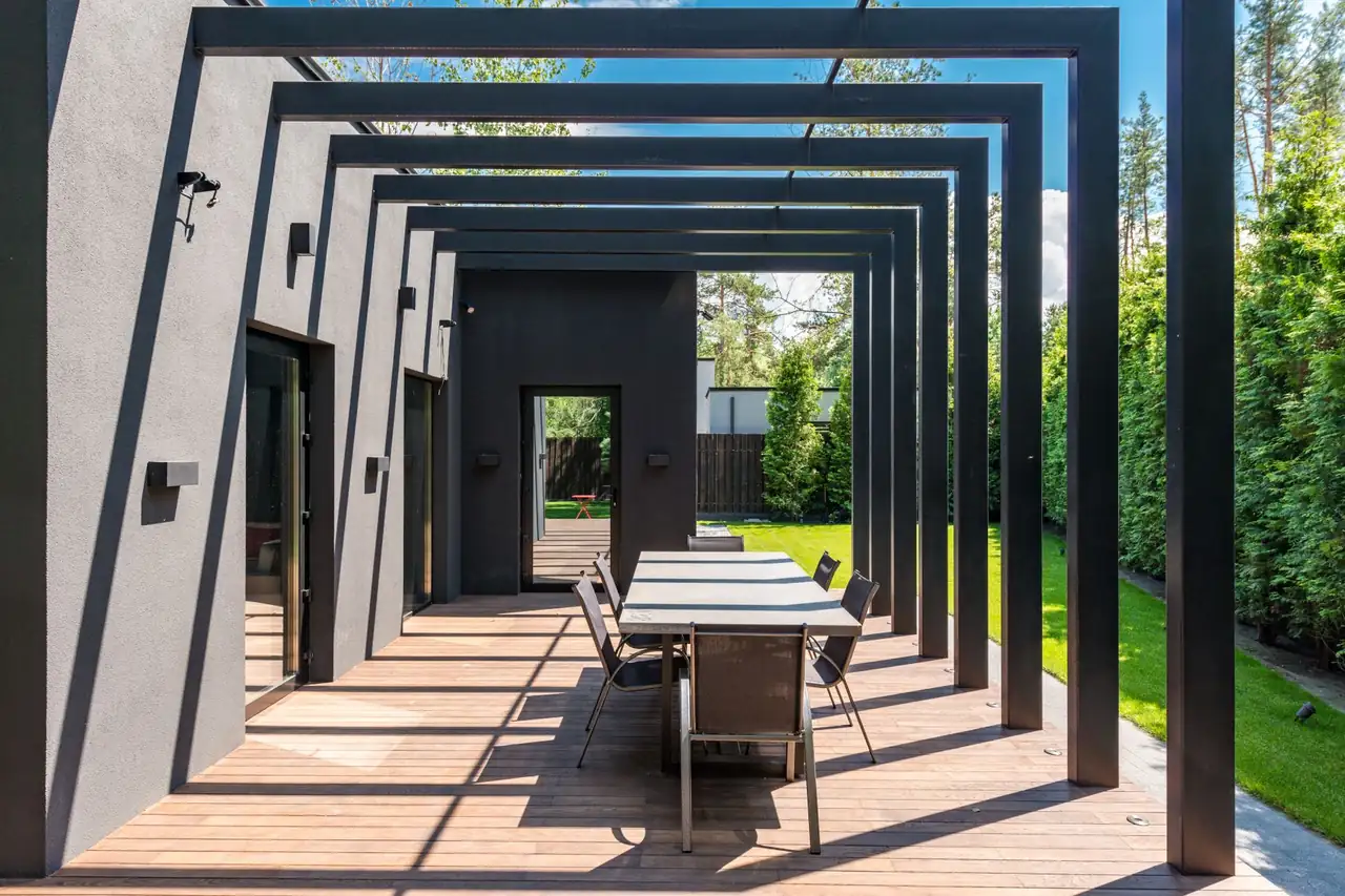 A contemporary patio shaded by a timber pergola